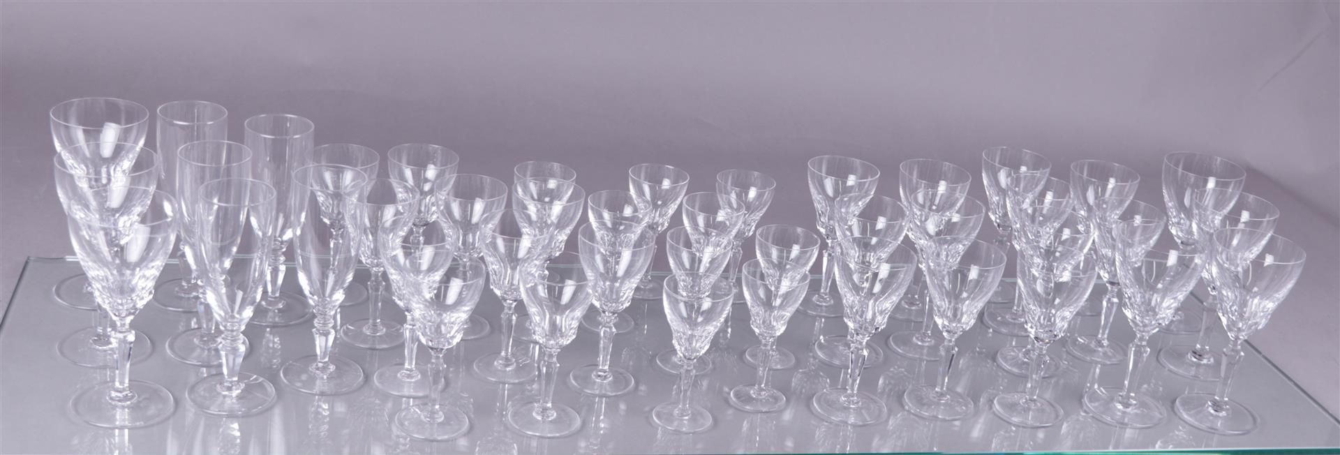 A large crystal tableware consisting of seven red wine glasses, twelve white wine glasses, ten desse