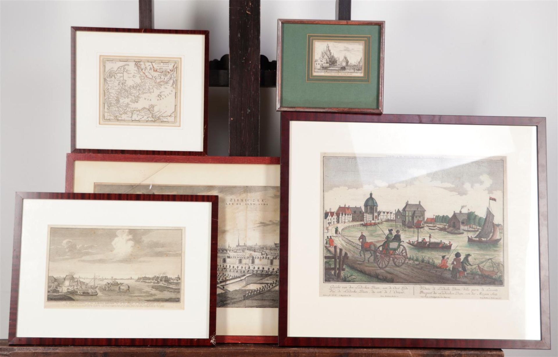 A lot containing (5) various prints including an optics print of Leidschendam, a cityscape of Zierik