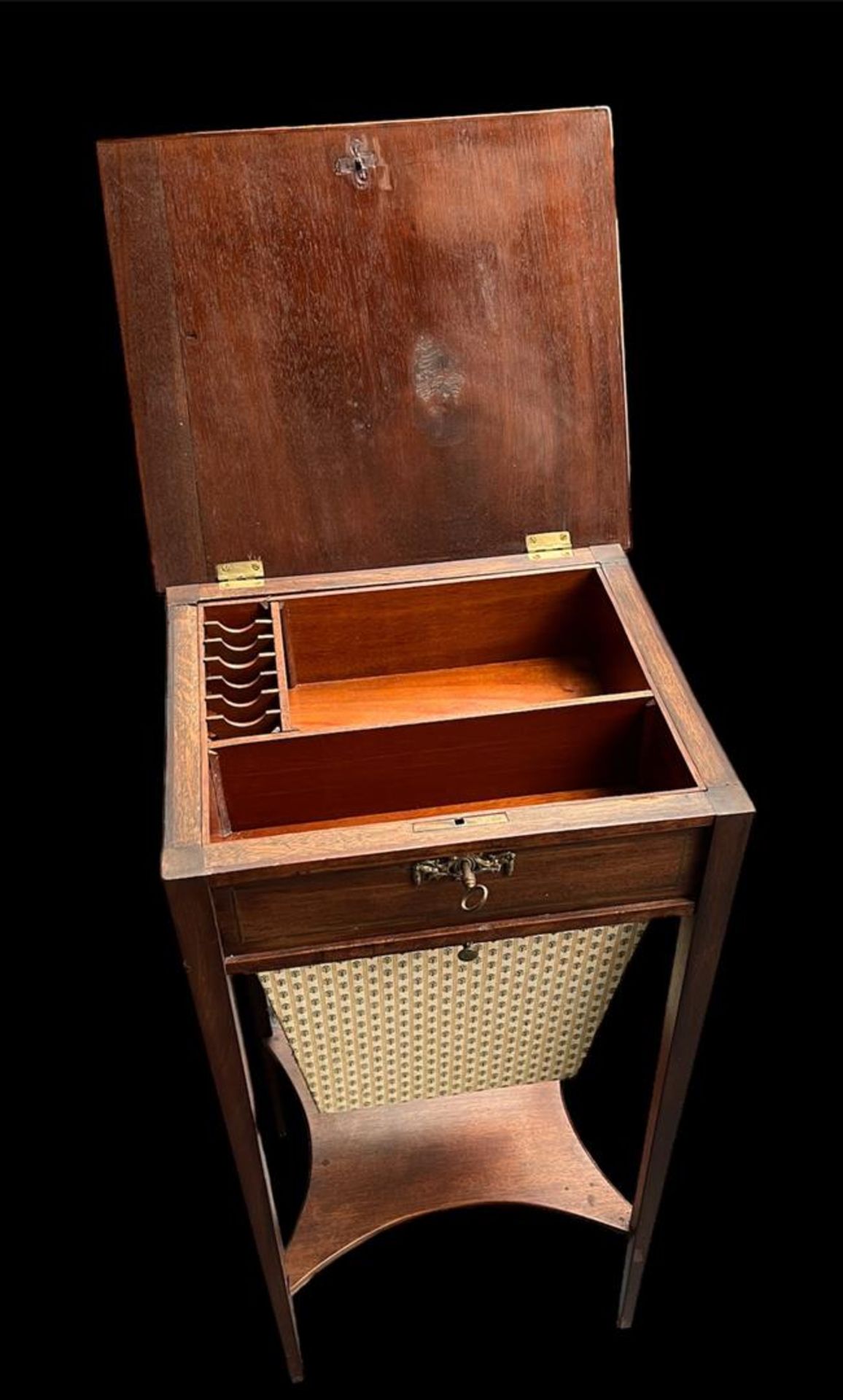 A mahogany, Louis Seize sewing table with compartments under a flap and extendable sewing basket. Th