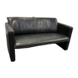 A black leather Leolux two-seater sofa, with label.