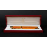 A Cartier pen set, Must de Cartier, consisting of a fountain pen and a ballpoint pen, in box and wit