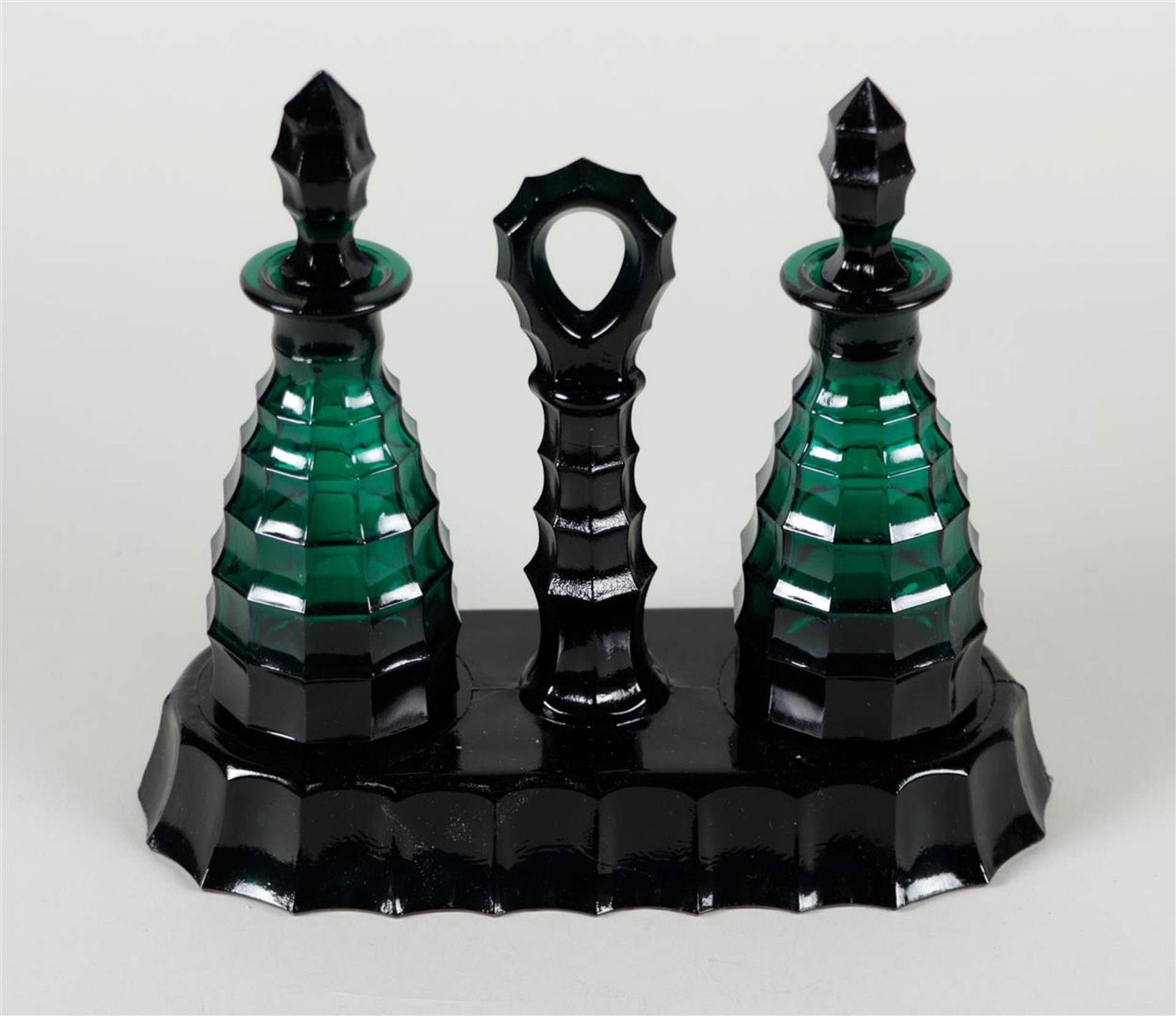 A pressed green glass oil and vinegar set, 20th century.