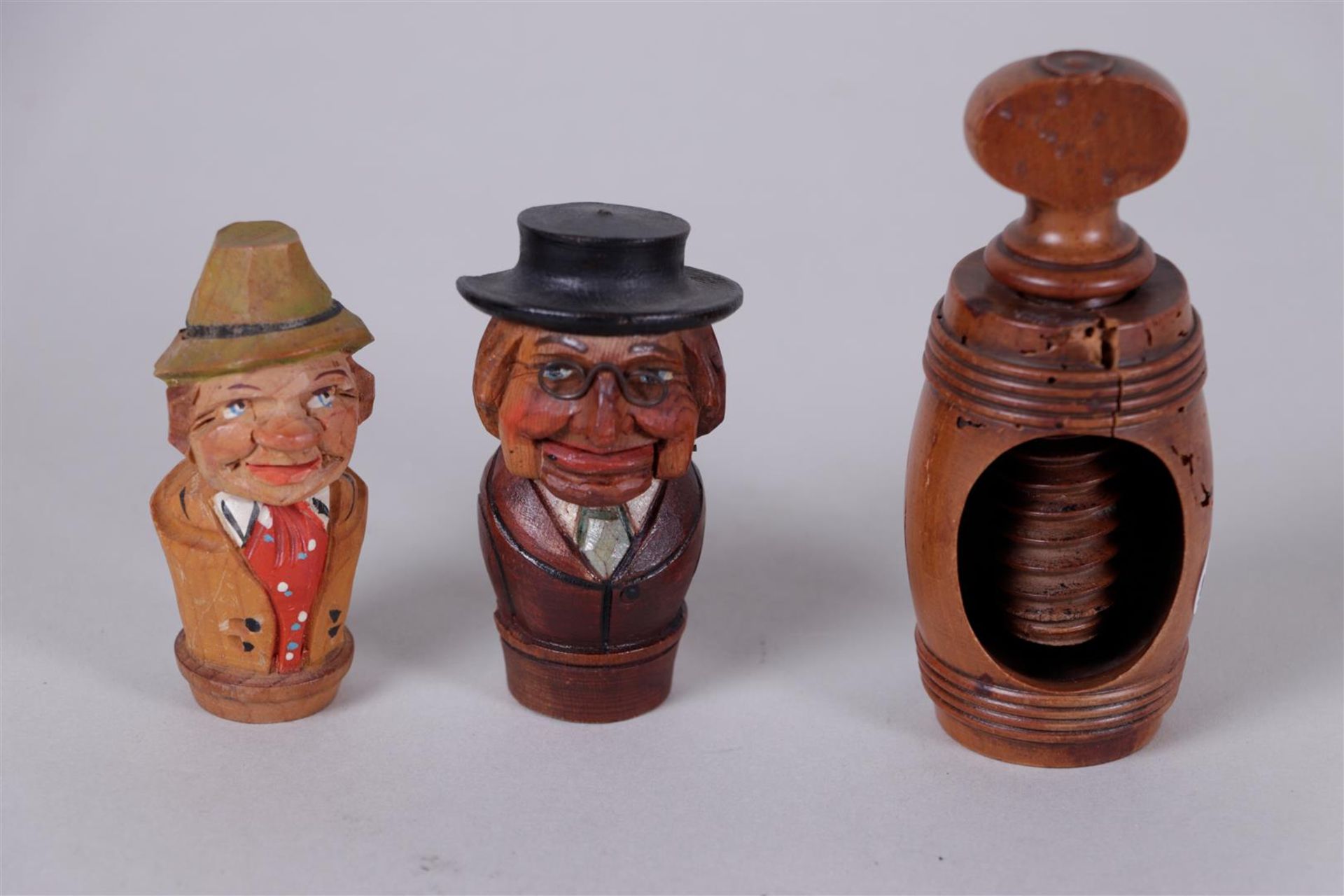 A nutcracker and two carved wooden corks.