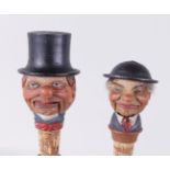 A lot with (2) bottle stoppers in the shape of a farmer's head with a moving mouth. (damaged), Black