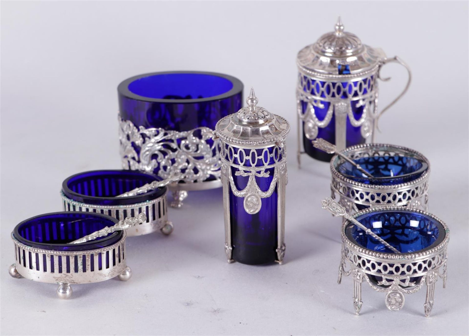 A lot consisting of (2) spice trays with matching spoon, both with blue glass inner containers. Mark