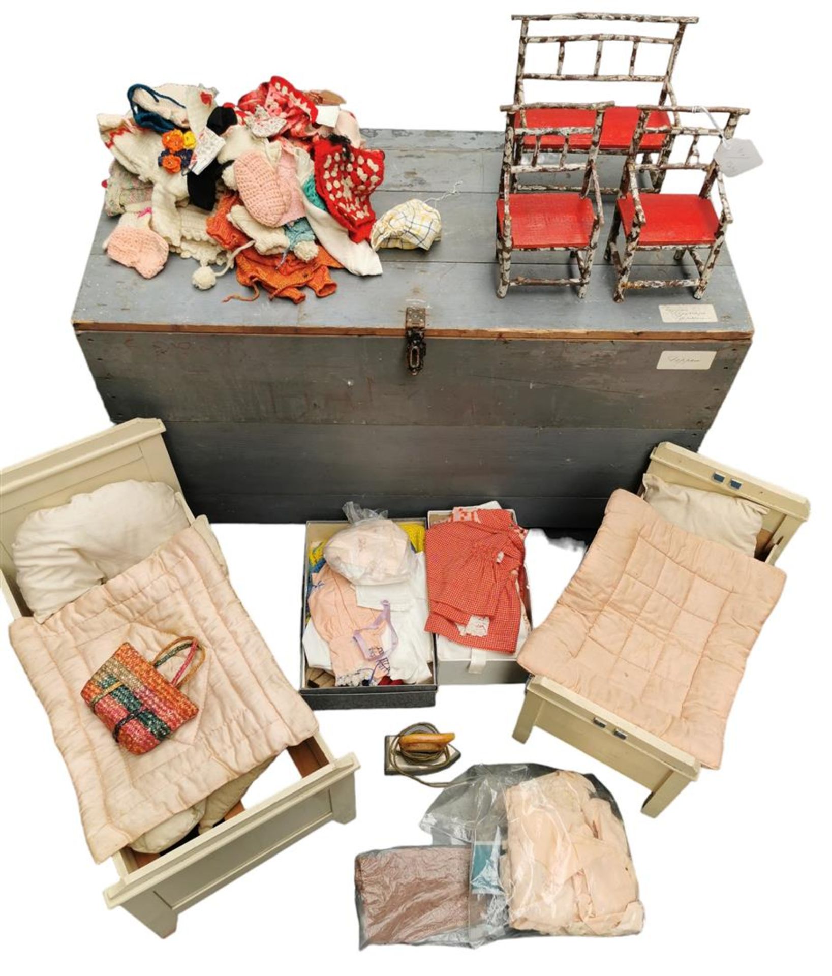 A large lot with doll furniture and clothing.