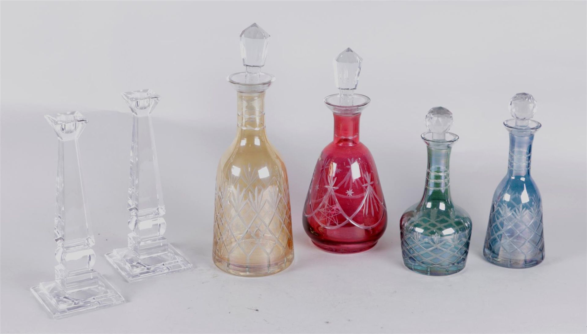 Lot of various glassware consisting of Bohemian decanters and crystal candlesticks.