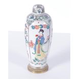A porcelain famile verte lidded vase decorated with long Elizas and flowers in beds, mounted on a br