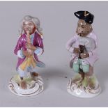 Two porcelain figures after Meissen example by Johann Joachim Kändler, monkeys playing music. Scheib
