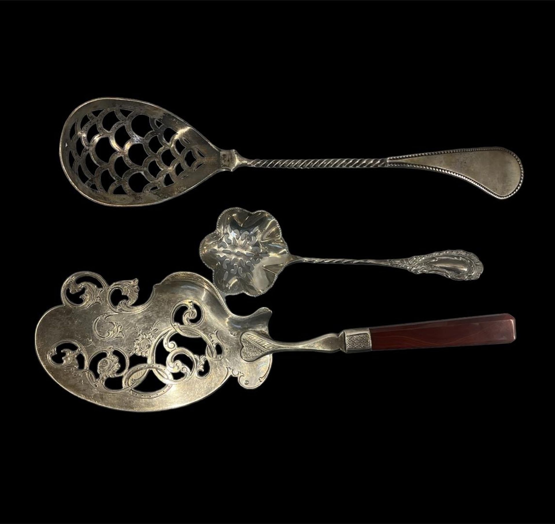 A lot consisting of a wet fruit scoop, a sprinkle spoon and a fish scoop, all marked.