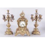 A cast brass mantle clock in rococo style, consisting of two 5-arm candelabra and a pendulum. 19th c