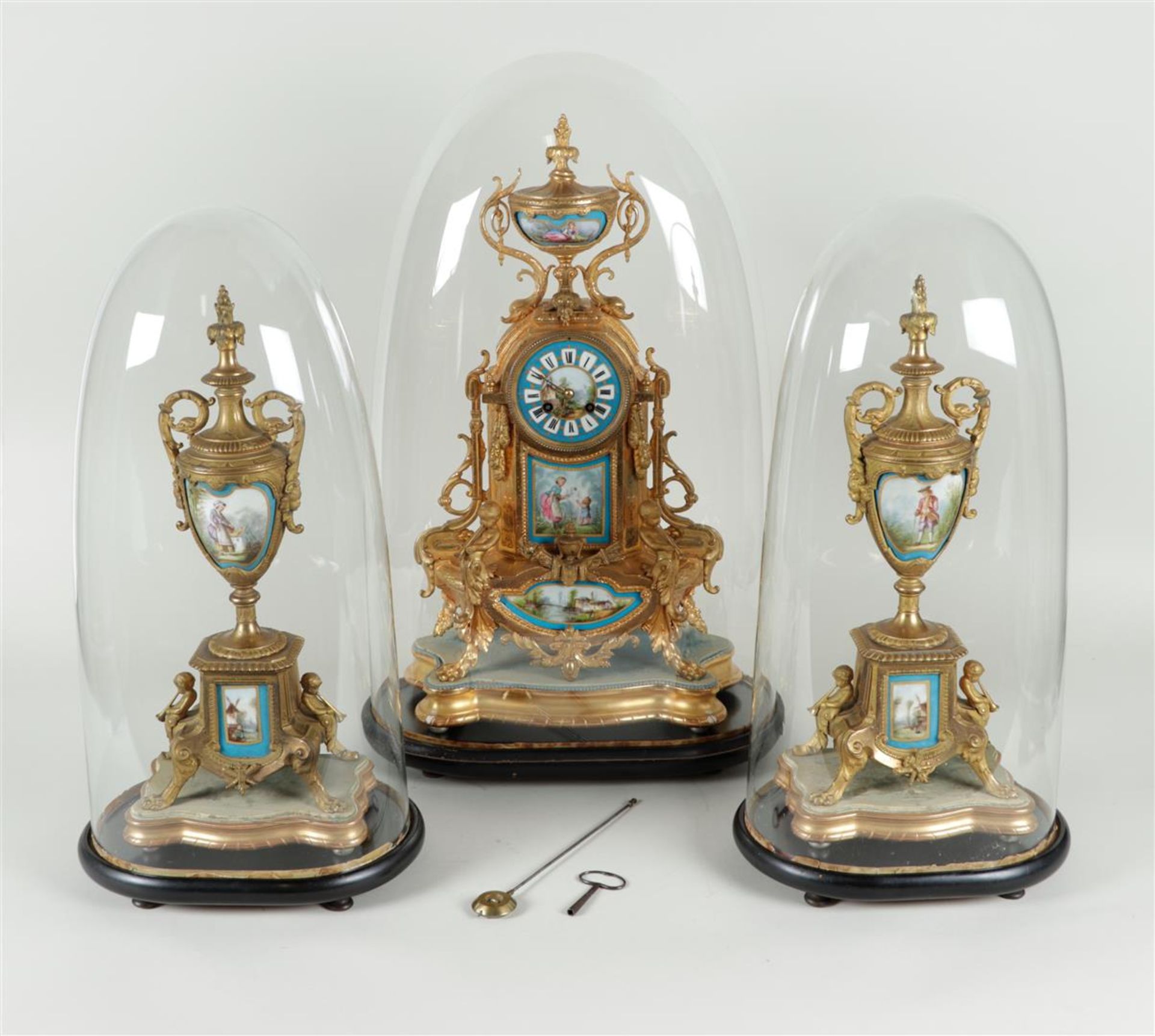 An ormolu-plated Garniture de Chéminée with porcelain plaques with scenes after Francois Boucher, al