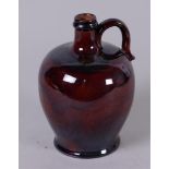 A brown glazed earthenware jug, marked Royal Doulton. England, 19th century.
H. 17 cm.