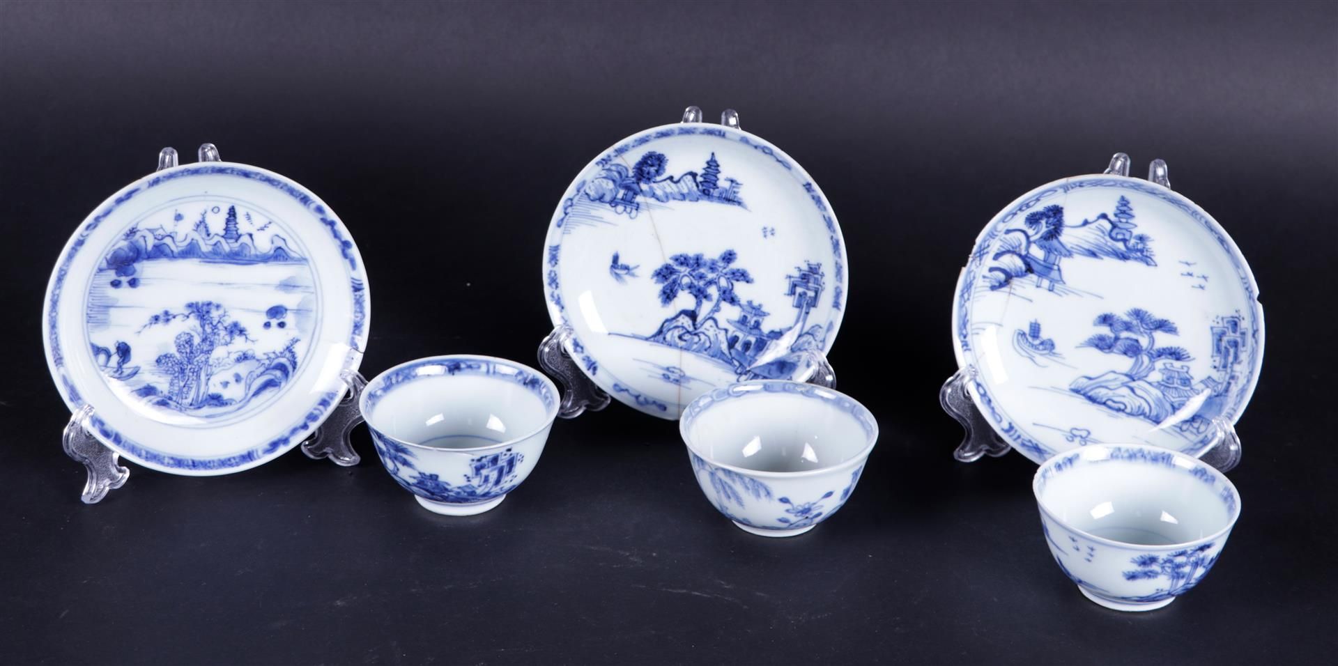 A set of (3) Porcelain cups and saucers blue-white with figures in river landscape, China, 18th cent