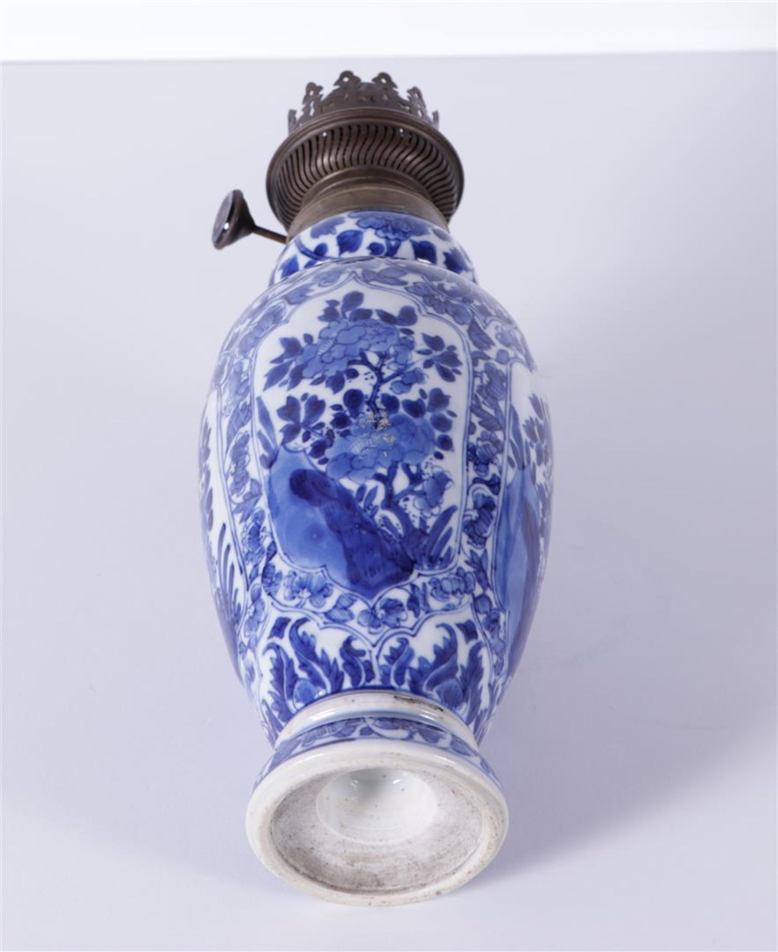 A porcelain baluster vase with floral decor. China, Kangxi. converted into an oil lamp.
H. 33 cm. - Image 3 of 3