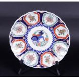 A porcelain Imari plate with kylin decor. Japan, 19th century.
Diam. 24 cm.