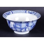 A porcelain hooded bowl with two scenes on the belly, and with playing fools in the interior. China,