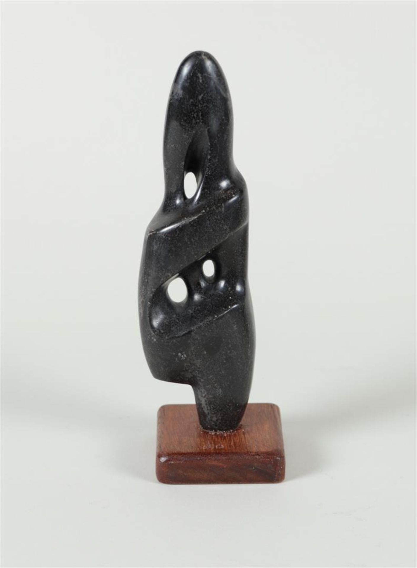 A unique stone figure on a wooden base, signed 'Lobo' (in the base),
23,5 (incl. sokkel).
