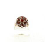 14kt rose gold rosette ring set with red coral.
The ring is gracefully finished with twisted wire an