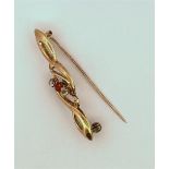 14kt yellow gold fantasy brooch set with 3 glass stones.
The brooch is set with 3 glass stones, cut 