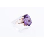 9kt Yellow gold statement ring set with one oval cut amethyst. 
Ring size: 55 / 17.25 mm.
Stone dime