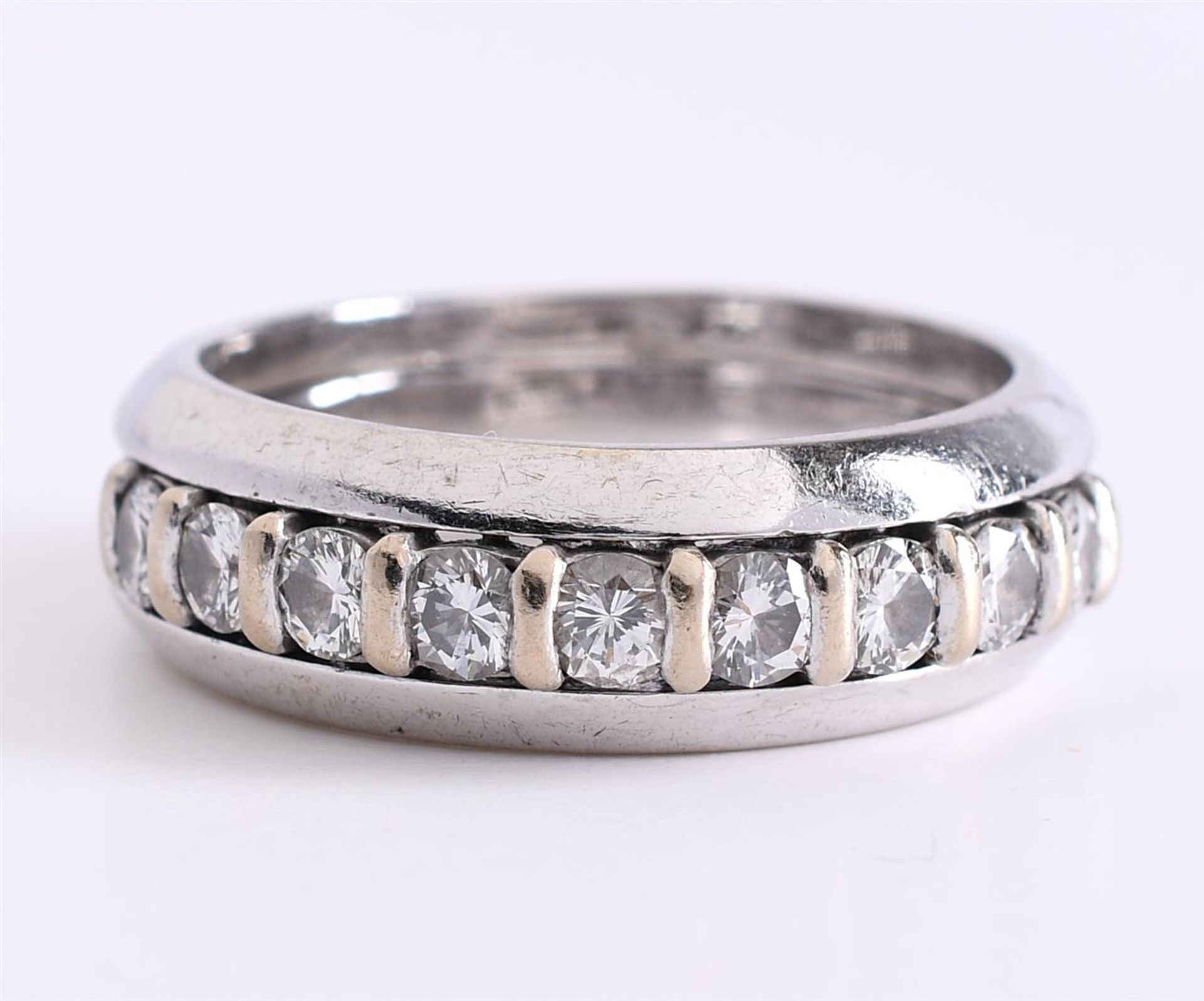 14/18 carat white gold wide row ring set with 9 brilliant cut diamonds of approx. 0.08 ct. With a to