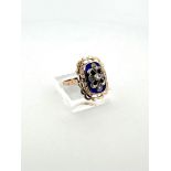 14kt bicolor gold antique appliqué ring with openwork scalloped edge, blue glass and rough diamond.
