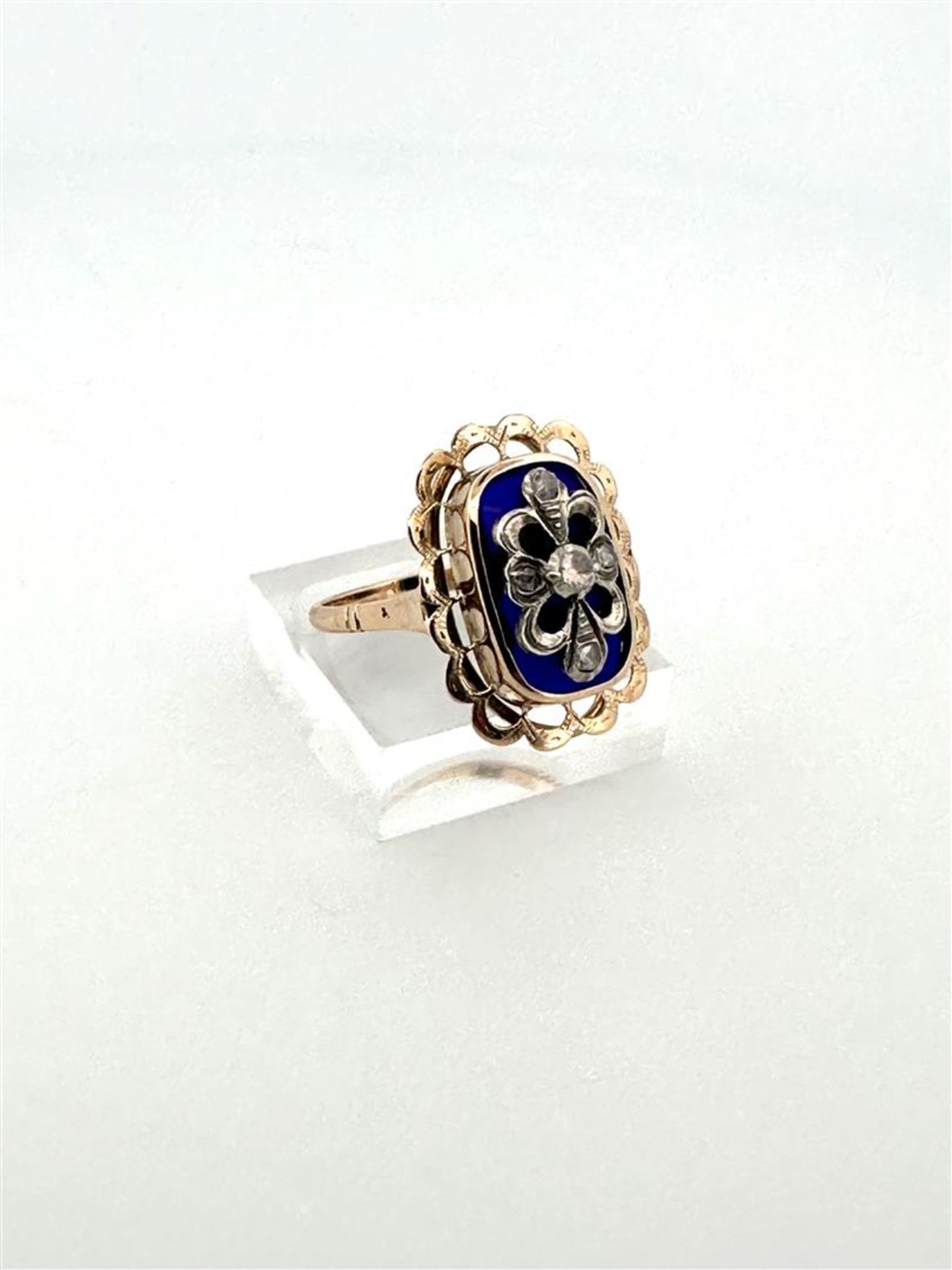 14kt bicolor gold antique appliqué ring with openwork scalloped edge, blue glass and rough diamond.
