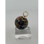 18kt yellow gold globe pendant inlaid with enamel and gemstones.
The globe also has a name for each 