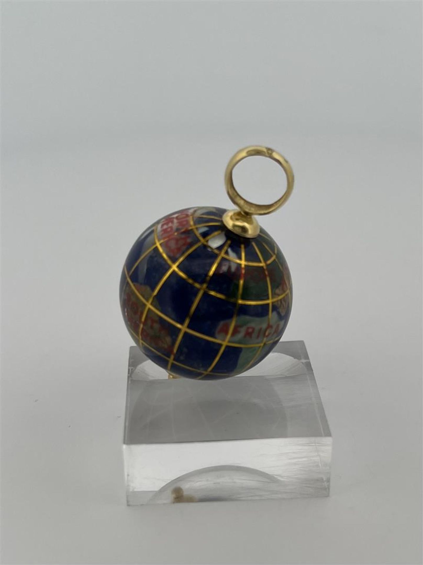 18kt yellow gold globe pendant inlaid with enamel and gemstones.
The globe also has a name for each 
