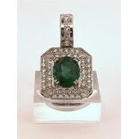 14kt white gold "art deco" pendant set with diamond and emerald.
This beautiful pendant is openwork 