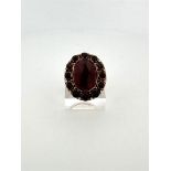 14kt yellow gold cocktail ring set with garnet.
The ring is set with 1 oval rose cut garnet measurin