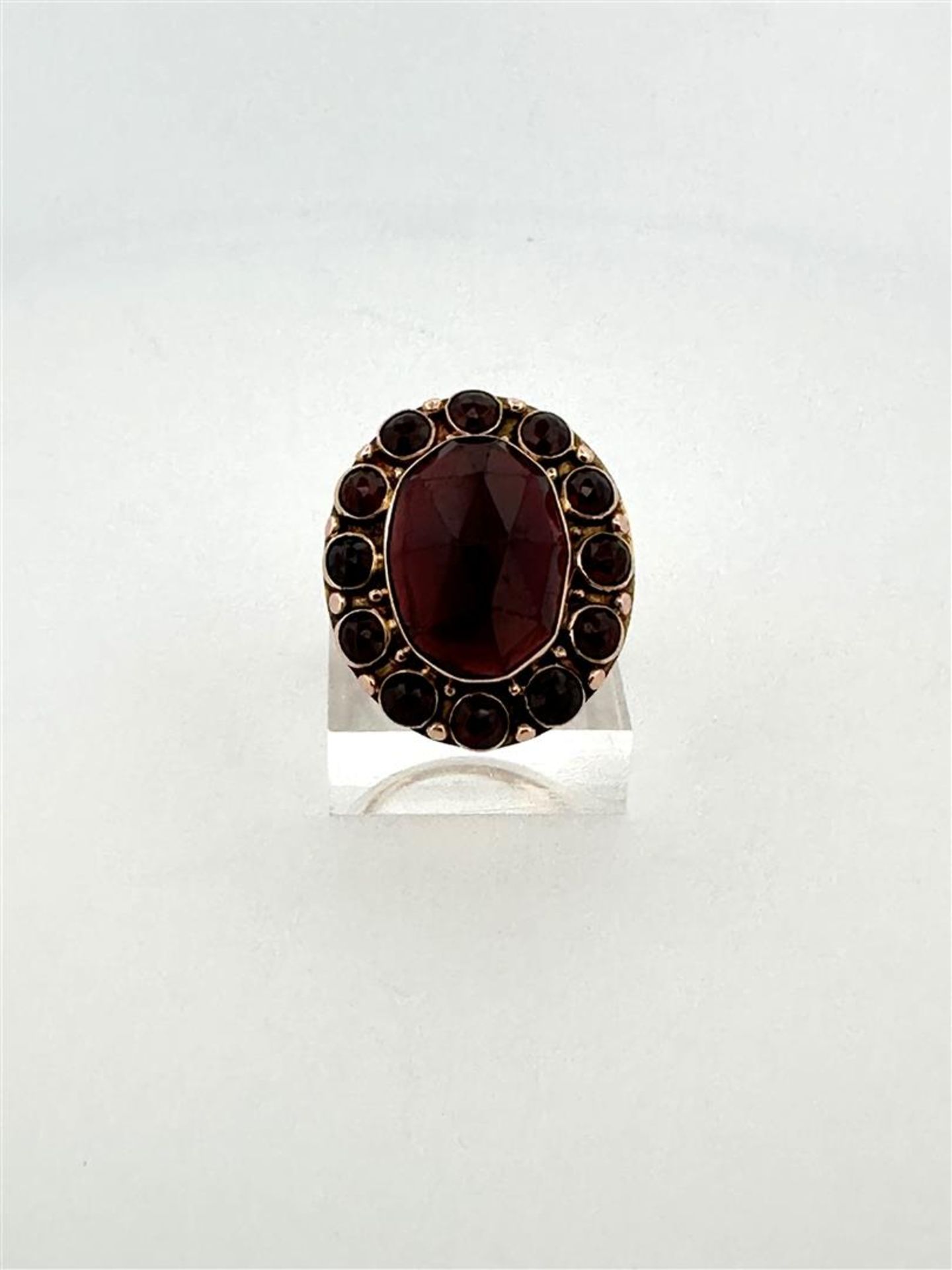 14kt yellow gold cocktail ring set with garnet.
The ring is set with 1 oval rose cut garnet measurin