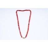 14kt yellow gold strung necklace with gold locks of red coral beads.
The necklace has approximately 