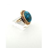 18kt yellow gold statement ring set with blue turquoise gemstone. 
The turquoise is cabochon cut and