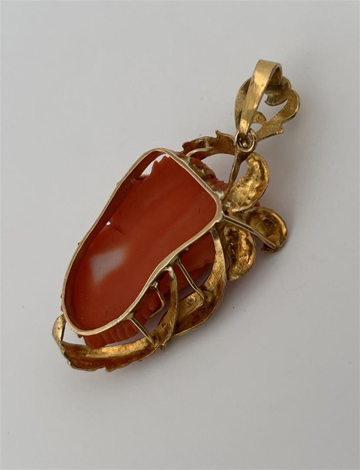 18kt yellow gold pendant set with carved coral.
The pendant is set with a beautiful carved coral in  - Image 2 of 4