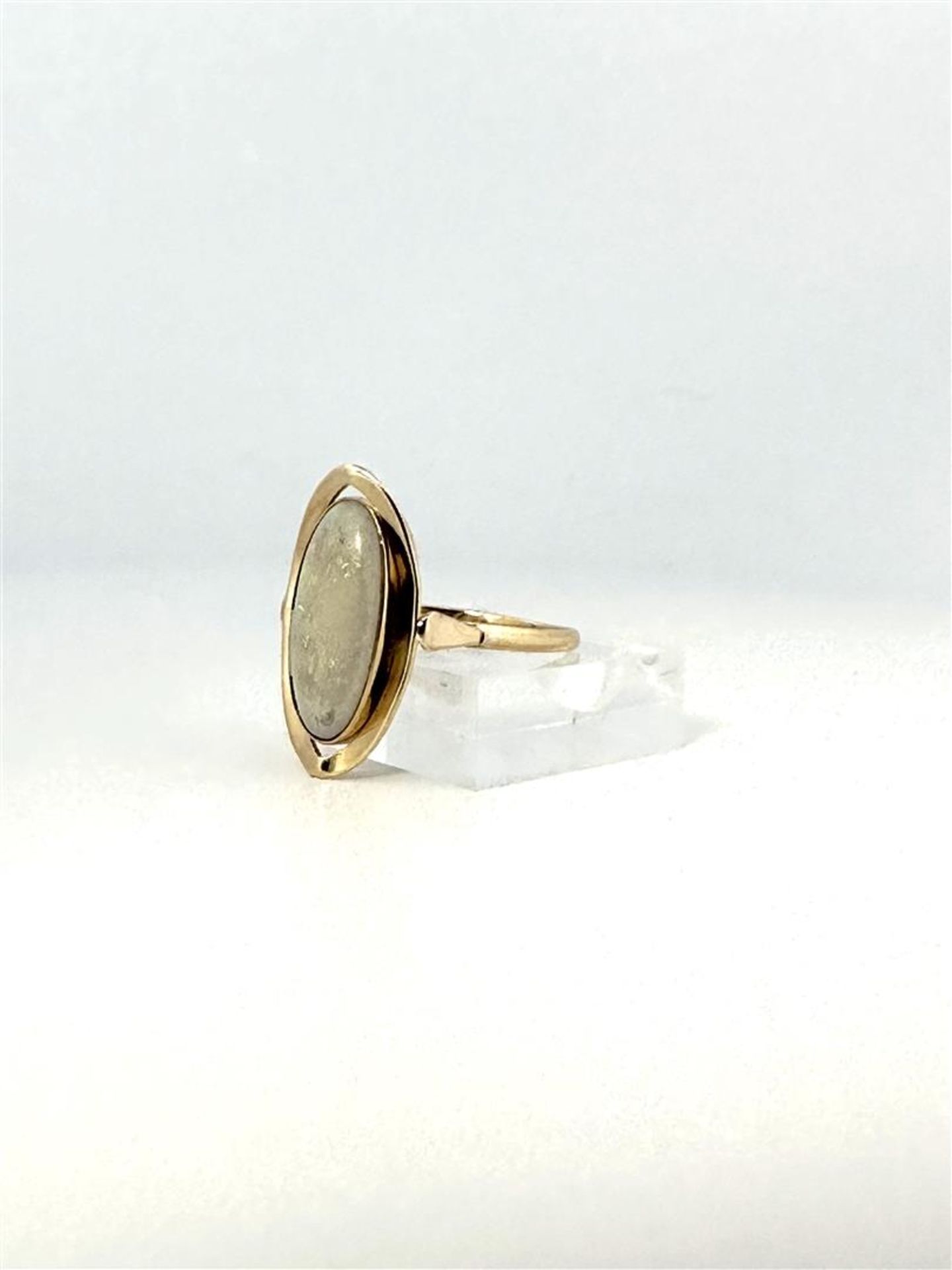 14kt yellow gold navette ring set with white opal. 
The white opal is cabochon cut in navette shape 