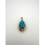 14kt yellow gold pendant set with turquoise and pearls.
The pendant is beautifully finished with gol