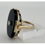 14kt Yellow gold ring set with onyx and diamonds.
The ring has a high openwork edge with a set onyx 