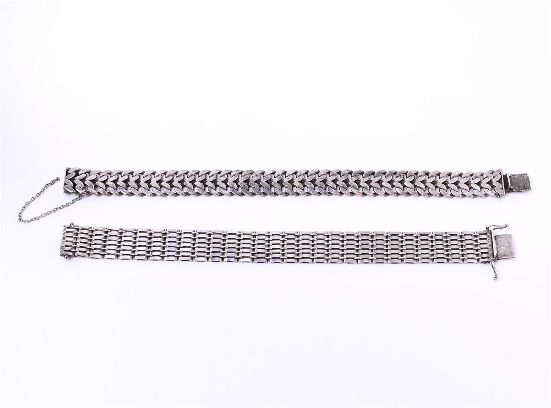 Two silver women's fantasy flat link bracelets, with a sliding clasp and safety chain and figure eig