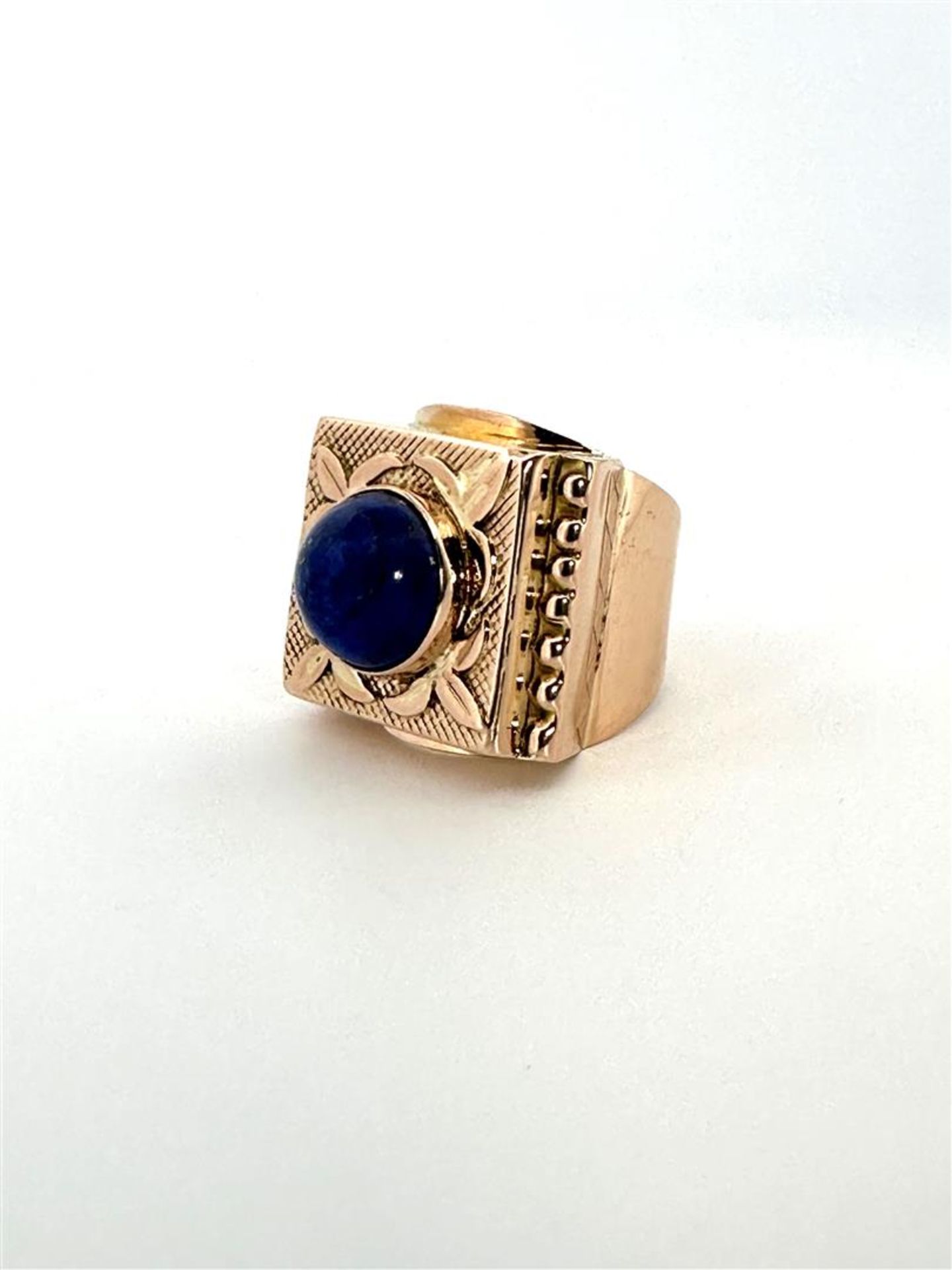 18kt yellow gold statement college ring set with Lapis Lazuli. 
The lapis lazuli is round and caboch