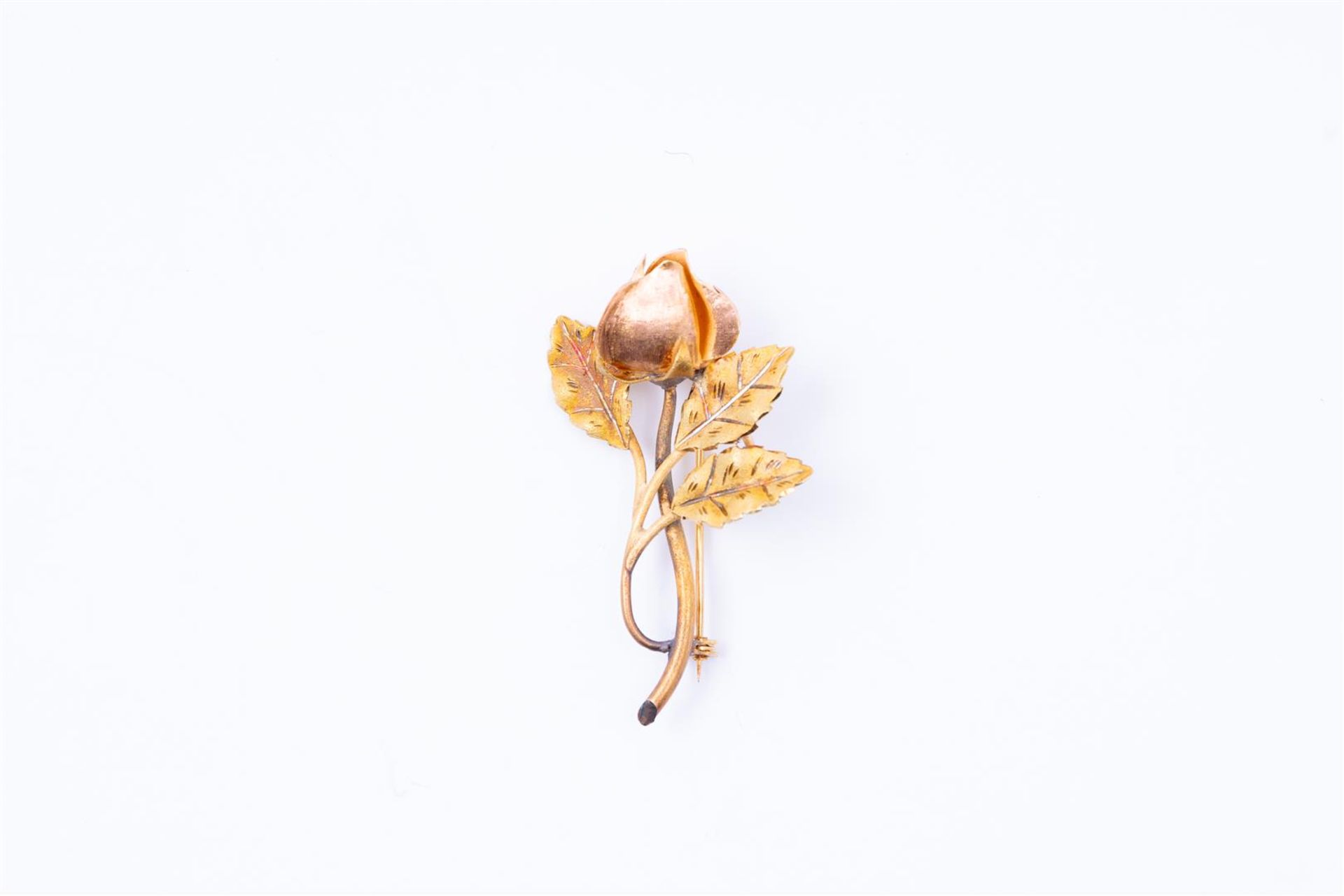 14kt Bicolor gold brooch in the shape of a rose. The bud of the rose is made in rose gold and the le