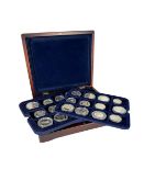 A collection of 36 silver coins from various countries and with various subjects, set in a box.