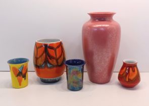 POOLE POTTERY - A vase decorated with a blue and orange pattern on a yellow back ground, pink lustre