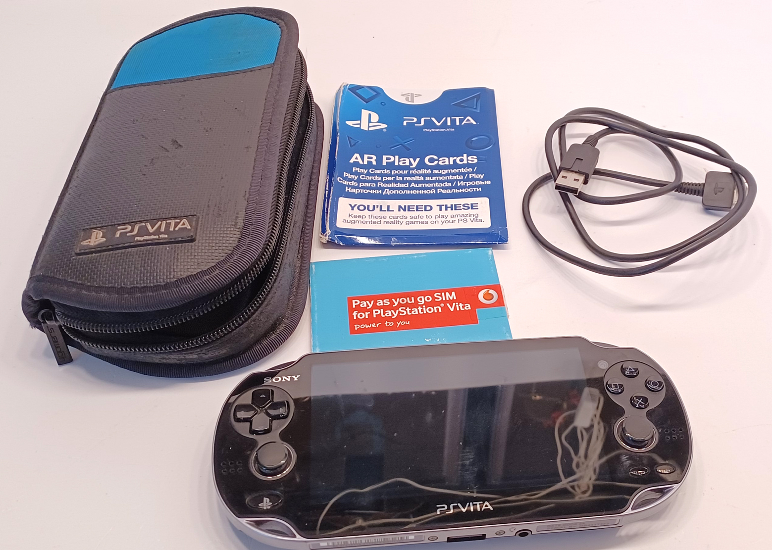 SONY PLAYSTATION PS VITA PCH-1103 WITH LEAD, PAPERWORK & TRAVEL CASE IN WORKING CONDITION.