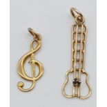 2 GOLD MUSICAL CHARMS/PENDANTS OF GUITAR WITH A SAPPHIRE AND TREBLE CLEF