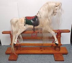 A 20th CENTURY DAPPLE GREY PAINTED ROCKING HORSE WITH LEATHERETTE TACK ON A TREADLE BASE LENGTH 45"