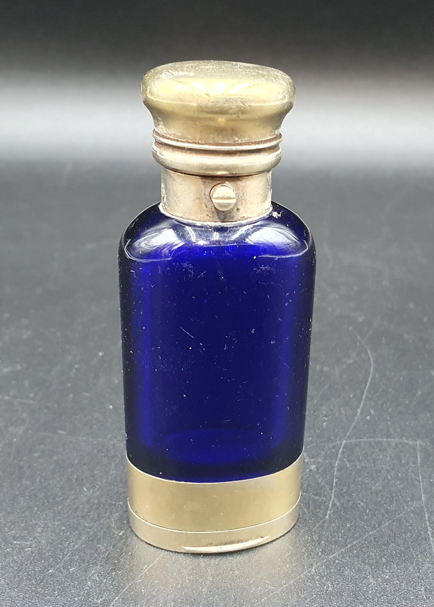 A Victorian silver-gilt mounted blue glass Scent Bottle/Vinaigrette with finely scroll pierced and