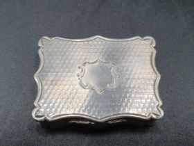 A Victorian silver rectangular Vinaigrette with engine turning and vacant cartouche, scroll