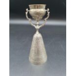 A George V silver Wager Cup with floral and leafage scroll decoration,inscribed Grocers Hall 1910,